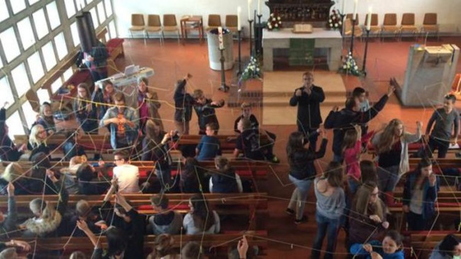 Blick von der Empore auf einen Schulgottesdienst in einer modernen Kirche